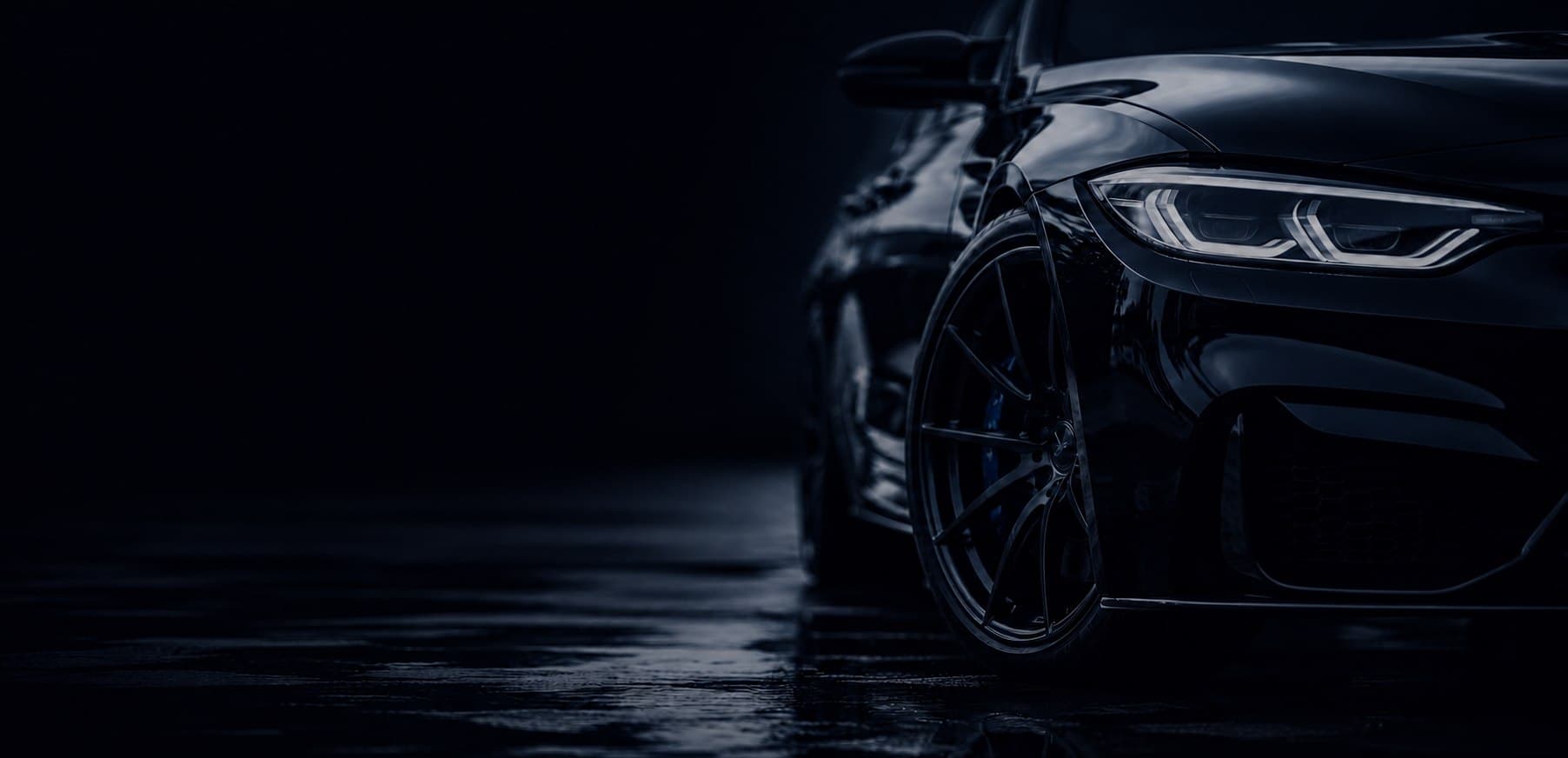 Detailed black luxury car in a dark studio